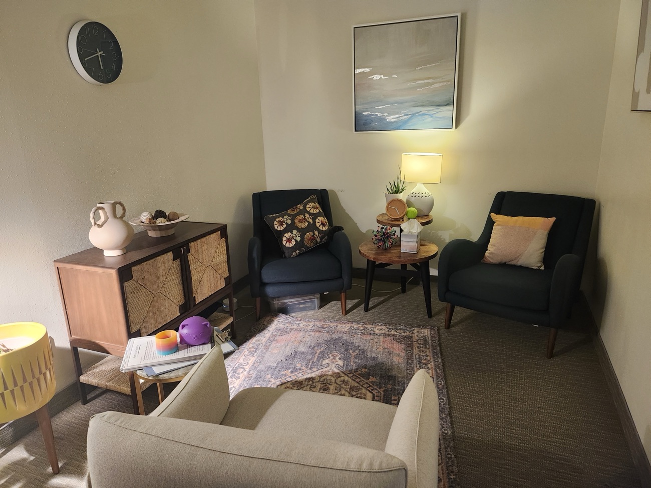A calm, sunlit therapy office with a comfortable chair and warm natural light